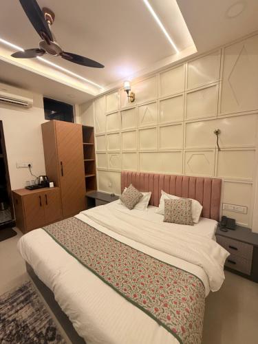 a bedroom with a large bed with two pillows at Shanti Vilas Hotel in Jaipur