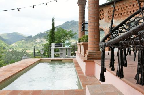 a swimming pool on the balcony of a house at Villa Mia Lucca - Modern Comfort in the Tuscan Hills in Lucca