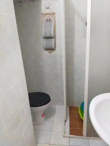 a small bathroom with a toilet and a sink at loft indipendente con giardino a Roma Tor vergata in Rome
