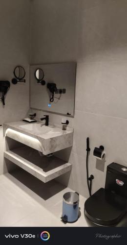 a bathroom with a sink and a toilet at فندق فيوري - المطار in Taif