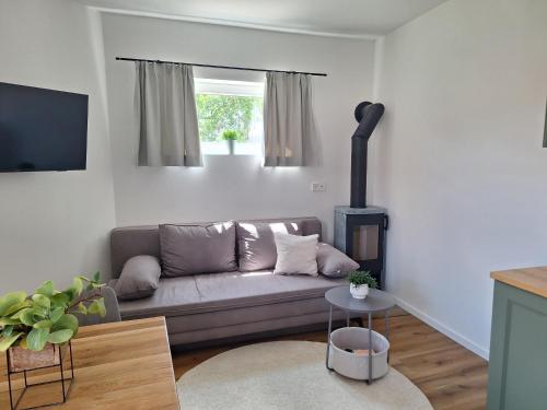 a living room with a couch and a fireplace at Kleinod Kirchensteig - Ferienwohnungen in der WACHAU in Weissenkirchen in der Wachau
