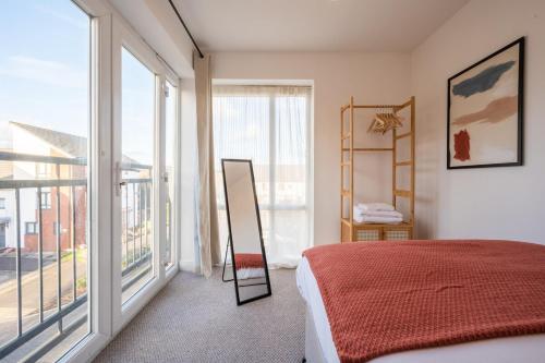 a bedroom with a bed and a large window at Atlanta's Residence by Tŷ SA in Newport