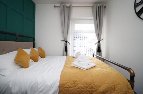 a bedroom with a bed with towels on it at Junctions Way by Tŷ SA -3 bed in Newport in Newport