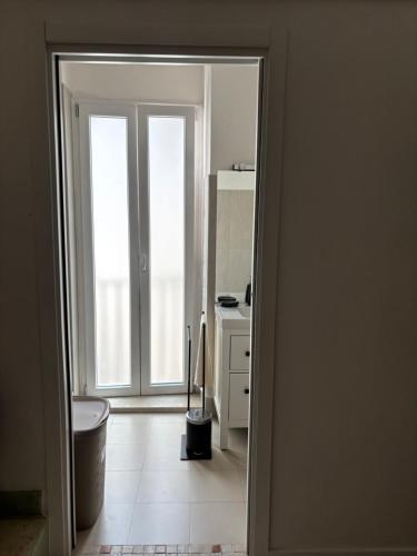 een open deur naar een keuken met een raam bij Maison Remì in Castellana Grotte