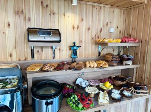 a bakery with various types of bread and pastries on shelves at Hotel Park in Batumi