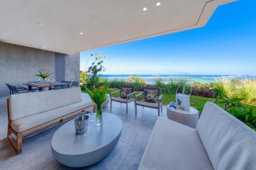 a living room with a view of the ocean at Domaine d'Anbalaba - Baie du Cap - Ile Maurice in Baie du Cap