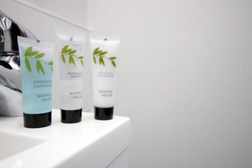 a group of four products on a shelf at Stunning sea views - Barry's Retreat by Tŷ SA in Barry