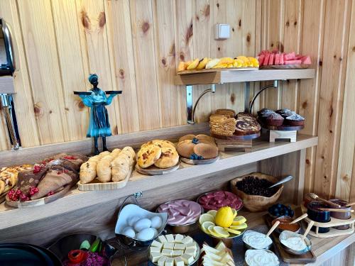 a display of bread and pastries on shelves in a bakery at Hotel Park in Batumi