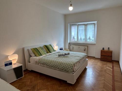 a bedroom with a bed and a window at Casa Rosy by Holiday World in Ivrea