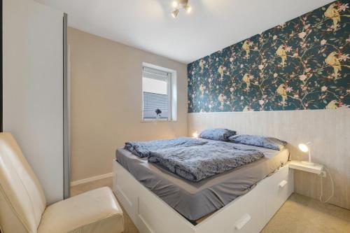 Un pat sau paturi într-o cameră la Ferienwohnung Eggers