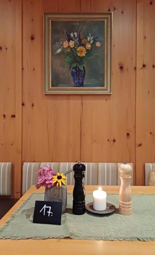 a table with a picture of a vase of flowers at Hotel Weyh in Pressath