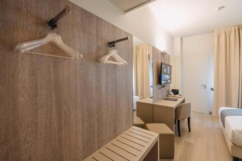 a hotel room with a bed and a desk at Living Hotel Milano in Cornaredo