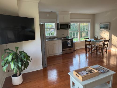 a living room with a table and a kitchen at Serenity in White Stone
