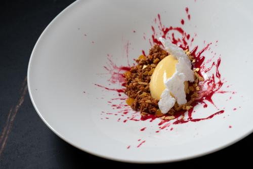 a white plate with a dessert on top of it at Hammerack Hotel, SPA & Wellness in Malborghetto Valbruna