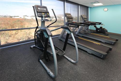 a gym with two treadmills in front of a window at avid hotel Guadalajara Aeropuerto Norte in Guadalajara