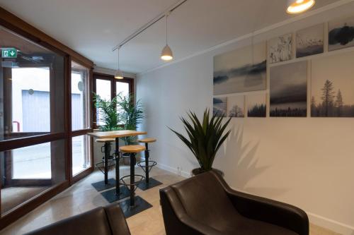 a living room with a table and a chair at Appart'Hotel Tournusien in Tournus