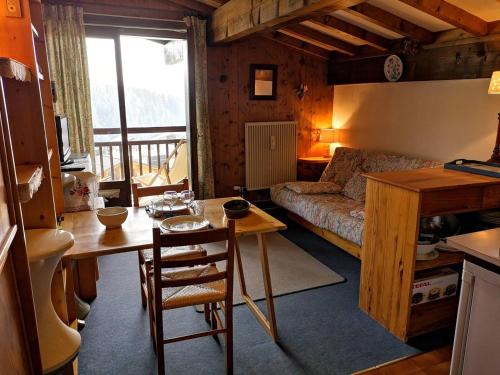 a living room with a table and a couch at Appartement studio à Notre-Dame-de-Bellecombe - 4 personnes NDB102-04G4 in Notre-Dame-de-Bellecombe