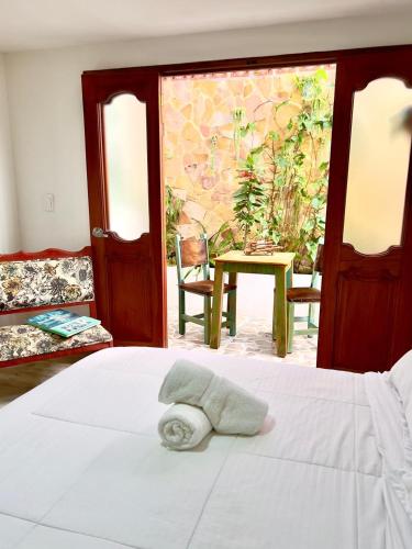 a bedroom with a bed with a towel on it at Paisa Territory Jardin in Jardin