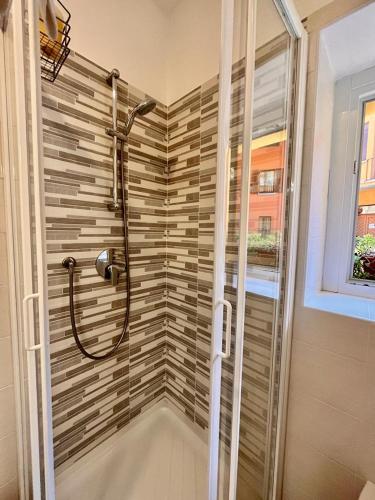 a bathroom with a shower with a glass door at BelSorriso Varese 2 - Elegance City Residence with Private Parking -Reservation Required- in Varese