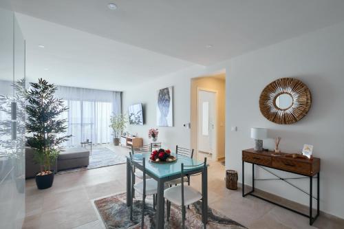 a living room with a table and a couch at Apartamentos Golfinho Dourado in Santa Maria