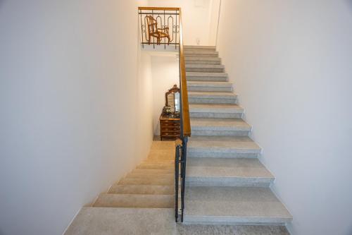 a stairway leading up to a room with white walls at Villa Erika Crikvenica in Crikvenica