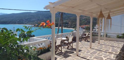 a pavilion with chairs and a view of the water at Emmy Rooms in Armenistis