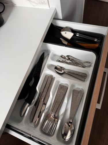 a drawer filled with silver utensils in a refrigerator at appartement 2 pièces in Saint Lo