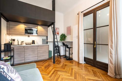 a room with a kitchen and a living room at 5 Guests Flat - Marais Enfants Rouges in Paris