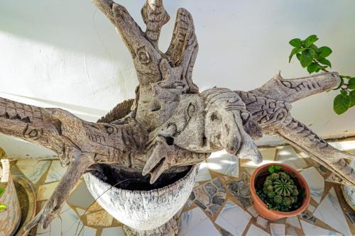 a moose head on a table next to a plant at TinJaLa Lodge in Brufut