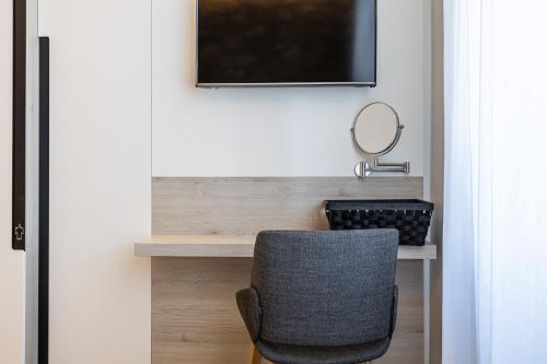 a chair sitting in front of a desk with a mirror at Villa Erika Crikvenica in Crikvenica
