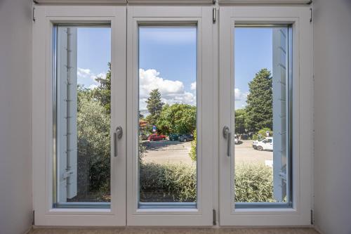 a pair of doors with a view of a street at Villa Erika Crikvenica in Crikvenica