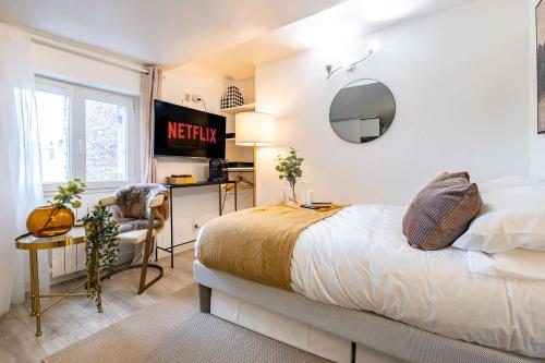 a bedroom with a bed and a desk and a chair at Studio in heart of Paris in Paris