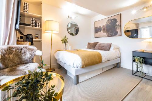 a bedroom with a bed and a chair at Studio in heart of Paris in Paris