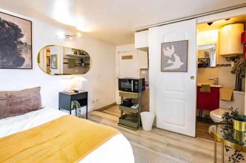 a bedroom with a bed and a dining room at Studio in heart of Paris in Paris