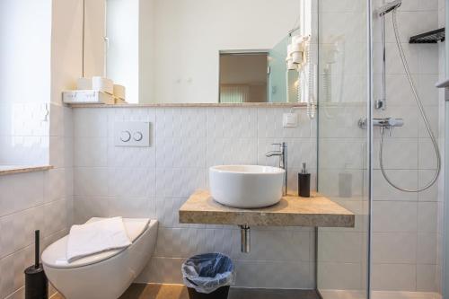 a bathroom with a sink and a toilet and a shower at Villa Erika Crikvenica in Crikvenica