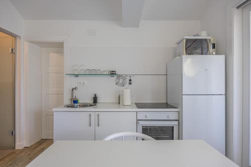 a white kitchen with a refrigerator and a sink at Villa Erika Crikvenica in Crikvenica