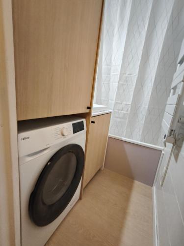 a washer and dryer in a small bathroom at Appartement a la Foux d'Allos in Allos
