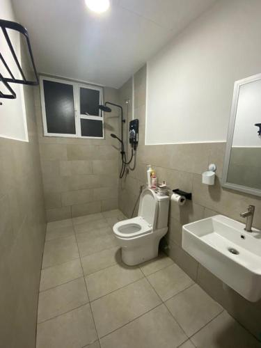 a bathroom with a toilet and a sink at FUMY Homestay in Kuantan