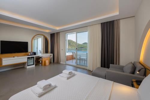 a hotel room with a bed and a television at Kas Marin Hotel in Kas