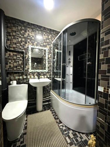 a bathroom with a toilet and a sink and a shower at Suu Hostel Downtown in Ulaanbaatar