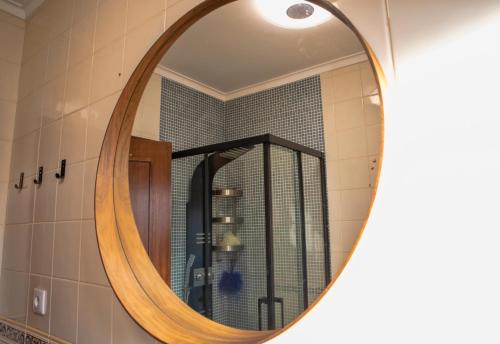 a mirror in a bathroom with a shower at Sta Luzia Villa Douro in Amarante