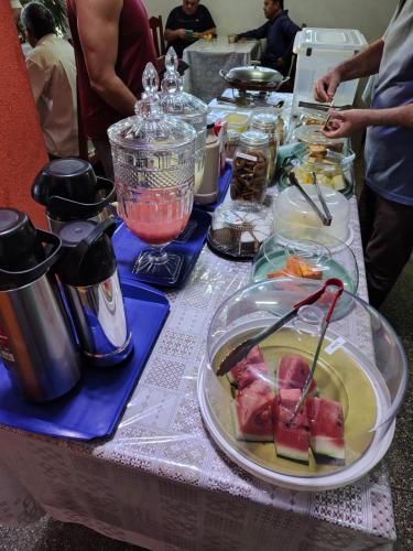 a table with a plate of food on it at Hotel Jardim Goiás in Rio Verde