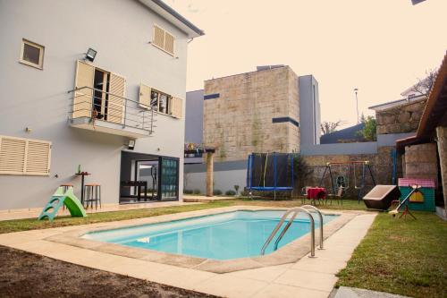 a swimming pool in the backyard of a house at Sta Luzia Villa Douro in Amarante