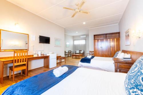 Ένα ή περισσότερα κρεβάτια σε δωμάτιο στο Karoo Country Inn
