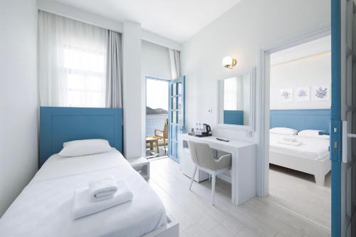 a bedroom with a bed and a desk and a sink at Kas Marin Hotel in Kas