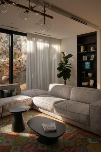 a living room with a couch and a table at Kuk Oaza Luxury Villas in Makarska