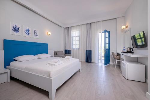 a bedroom with a bed and a desk in a room at Kas Marin Hotel in Kas