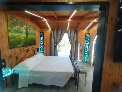 a bedroom with a bed and a window at Casale Del Vento in Aprilia