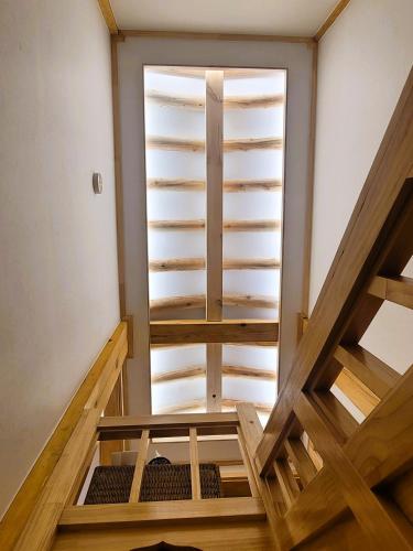 an attic room with stairs and a window at Insarang in Seoul