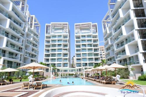 エイラットにあるtop suit eilatのアパートメントの建物の前のスイミングプールのイメージ
